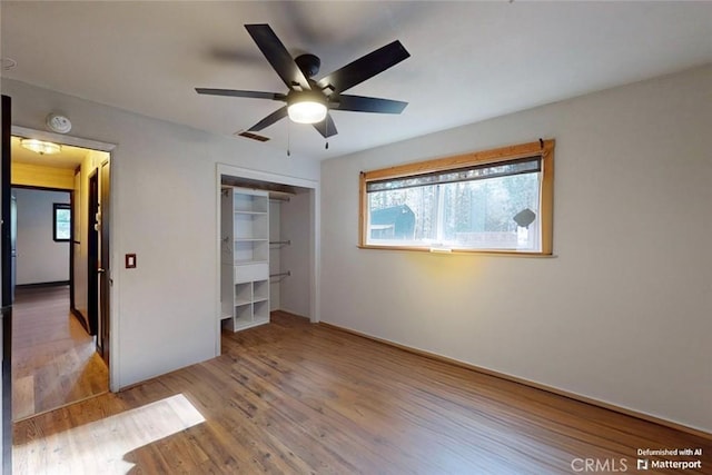 unfurnished bedroom featuring ceiling fan, a closet, and light hardwood / wood-style flooring