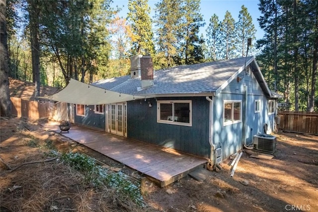 back of house featuring a wooden deck and central air condition unit