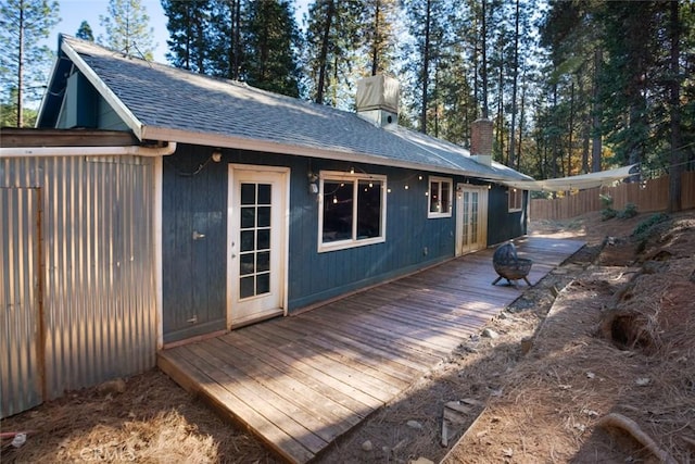 rear view of property with a wooden deck