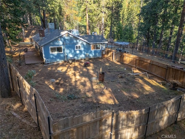 rear view of property with central AC unit