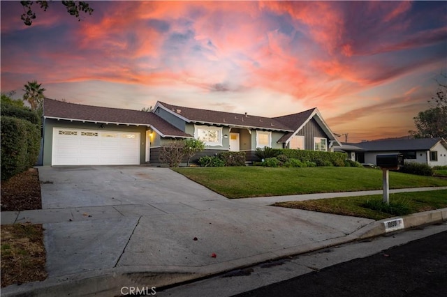 single story home featuring a garage and a yard