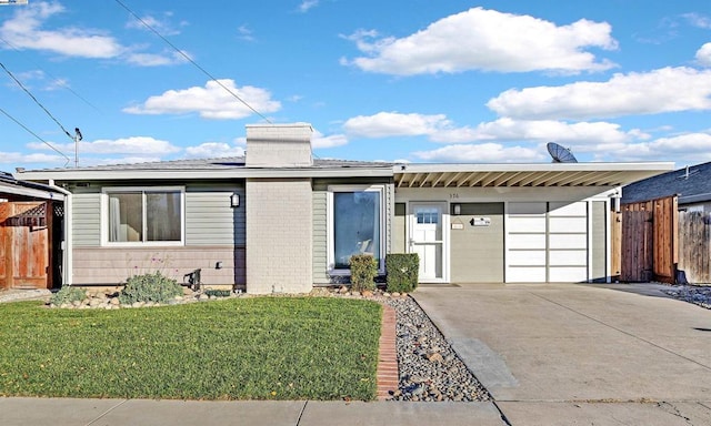 view of front of property with a garage and a front yard