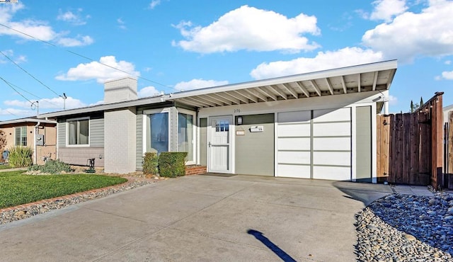 single story home with a front yard and a garage