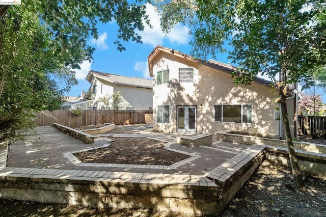 rear view of house with a patio area and french doors