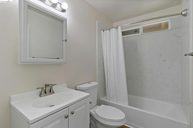 full bathroom featuring toilet, vanity, and shower / tub combo with curtain