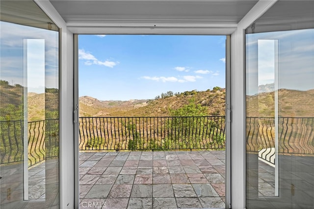 unfurnished sunroom with a mountain view