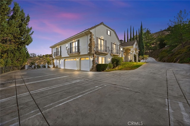 view of front of home with a balcony and a garage