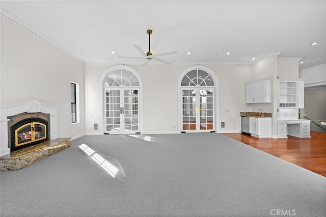 unfurnished living room with hardwood / wood-style floors, french doors, ceiling fan, and ornamental molding