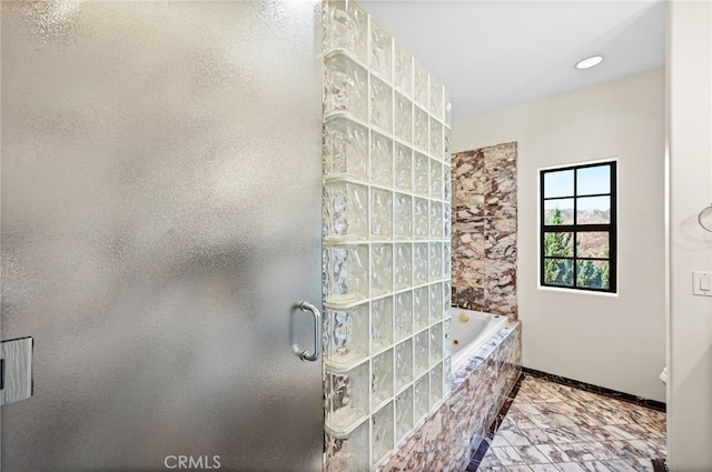 bathroom featuring separate shower and tub