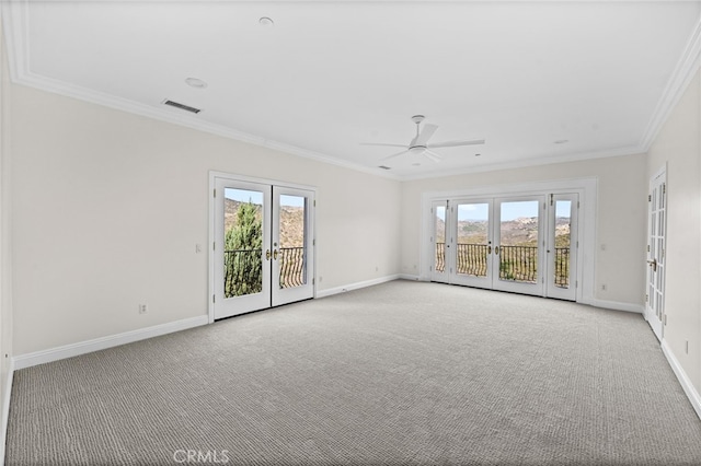 unfurnished room featuring french doors, light colored carpet, a healthy amount of sunlight, and ornamental molding