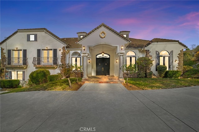 mediterranean / spanish home featuring french doors