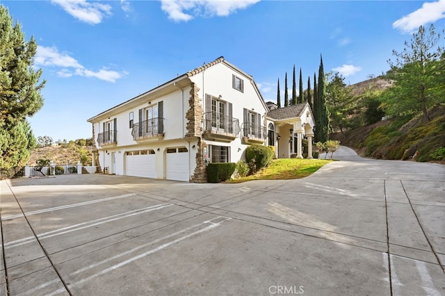 view of front of property with a balcony and a garage