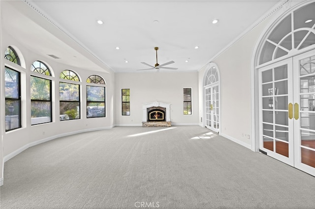 unfurnished living room with light carpet, ornamental molding, and a healthy amount of sunlight