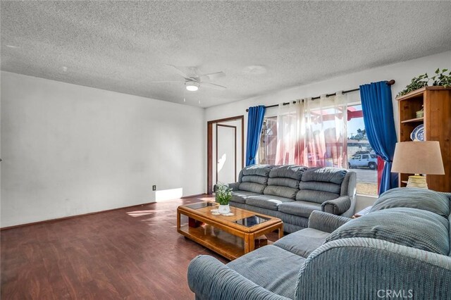 living room featuring a textured ceiling, ceiling fan, and hardwood / wood-style flooring