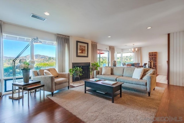 living room with a mountain view, hardwood / wood-style floors, and a notable chandelier