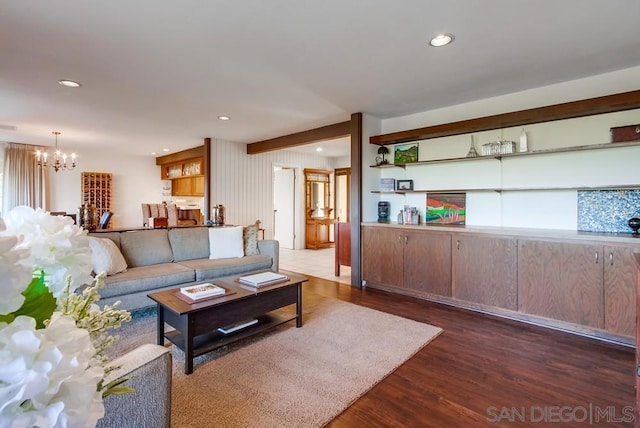 living room with a chandelier and dark hardwood / wood-style floors