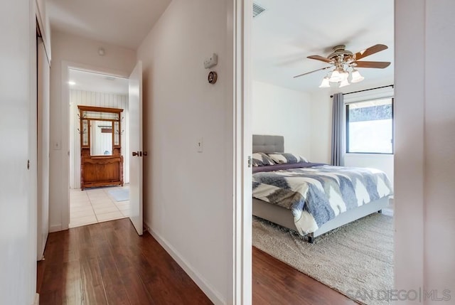 bedroom with hardwood / wood-style floors and ceiling fan