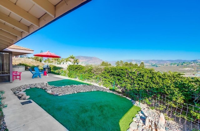 view of yard featuring a mountain view and a patio