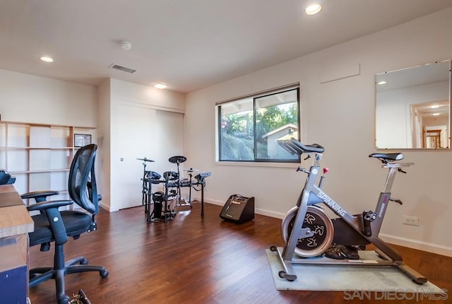 exercise room with dark hardwood / wood-style flooring