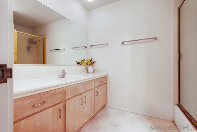 bathroom with shower / bath combination with glass door and vanity