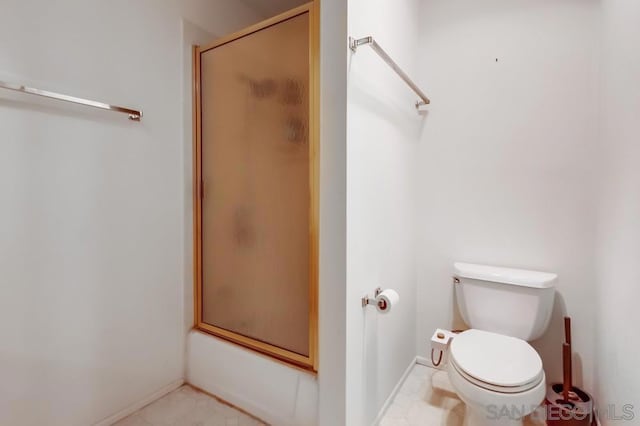 bathroom featuring shower / bath combination with glass door and toilet