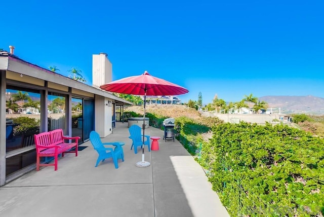 view of patio / terrace featuring a mountain view and area for grilling