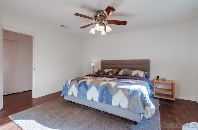 bedroom featuring ceiling fan and dark wood-type flooring