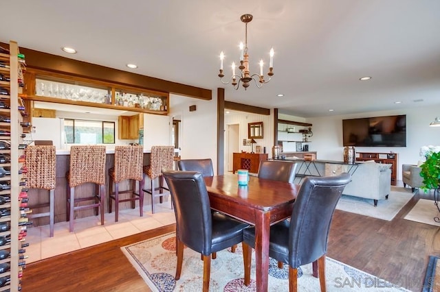 dining room featuring light wood-type flooring and a notable chandelier