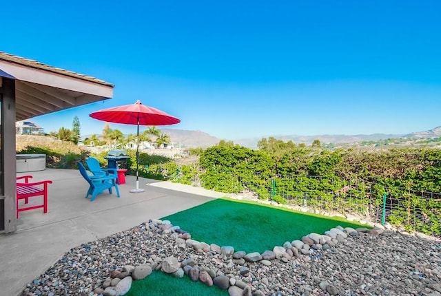 view of yard featuring a mountain view and a patio