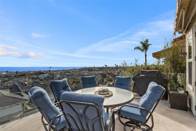 view of patio / terrace with a grill and a water view