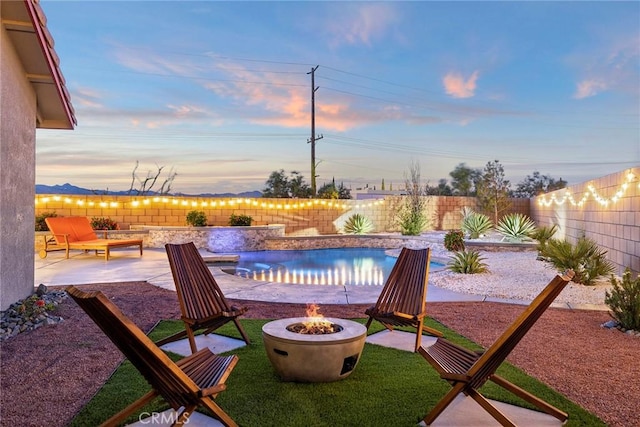 patio terrace at dusk with a fire pit