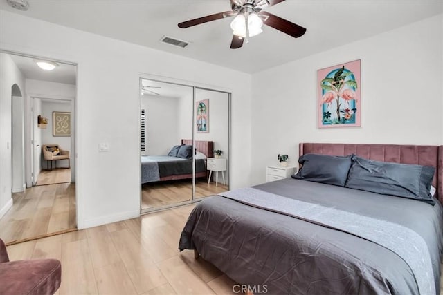 bedroom with hardwood / wood-style flooring, a closet, and ceiling fan