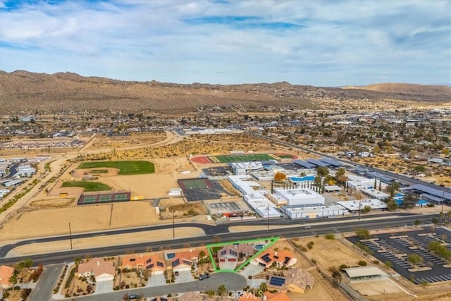 birds eye view of property with a mountain view