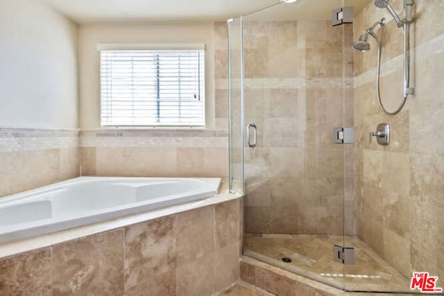 bathroom with shower with separate bathtub