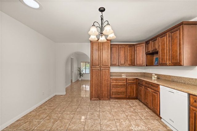 kitchen with hanging light fixtures, an inviting chandelier, light stone counters, white dishwasher, and light tile patterned flooring