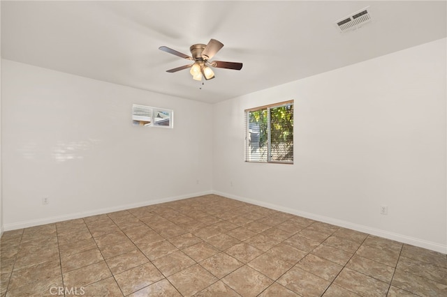 unfurnished room with ceiling fan and light tile patterned floors