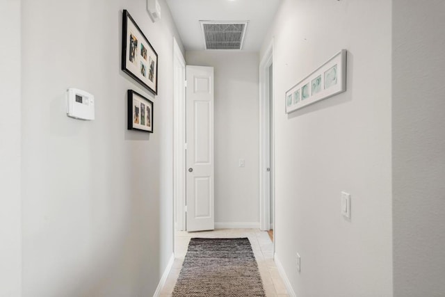 hall featuring light tile patterned floors