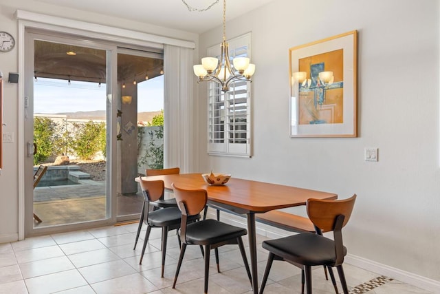 dining room with a notable chandelier and light tile patterned flooring