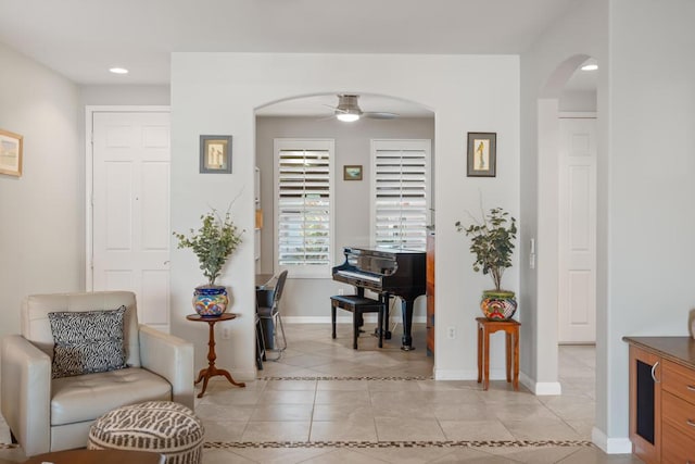 living area featuring ceiling fan and light tile patterned floors