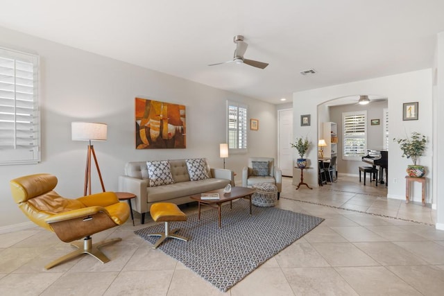 living room with ceiling fan and light tile patterned floors