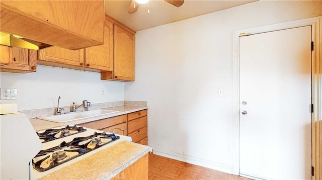 kitchen featuring ceiling fan, white gas cooktop, sink, and light parquet floors