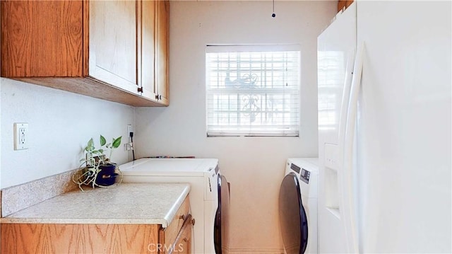 laundry room with cabinets and washer and clothes dryer