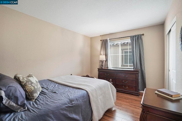 bedroom with dark hardwood / wood-style flooring