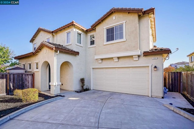 mediterranean / spanish-style home featuring a garage