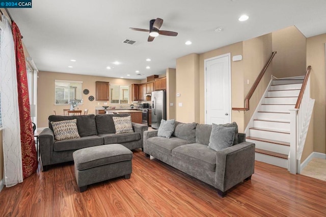 living room with ceiling fan and wood-type flooring