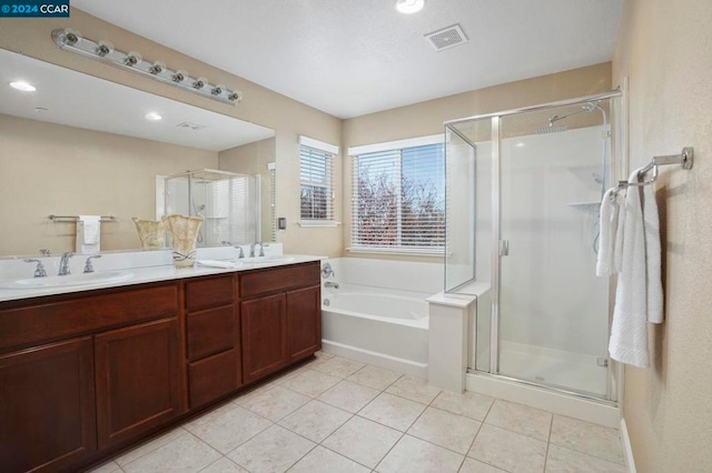 bathroom with tile patterned floors, vanity, and plus walk in shower