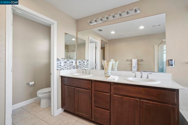 bathroom featuring tile patterned floors, vanity, decorative backsplash, toilet, and a shower with shower door