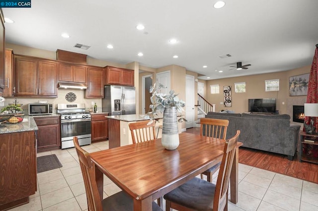 tiled dining area with ceiling fan