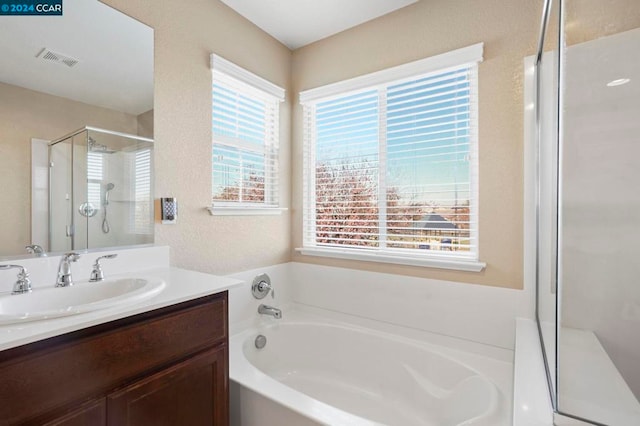 bathroom with separate shower and tub and vanity