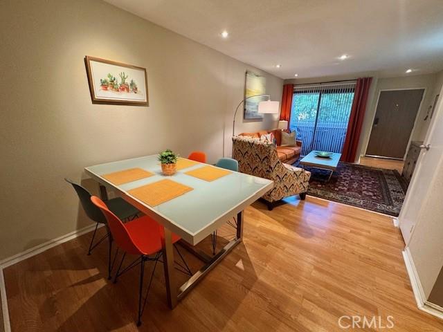 dining area featuring recessed lighting, baseboards, and wood finished floors